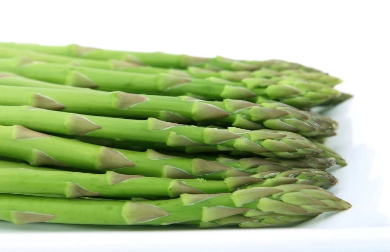 the asparagus are arranged neatly on the plate