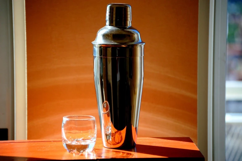 a bottle and a glass sitting on top of a table