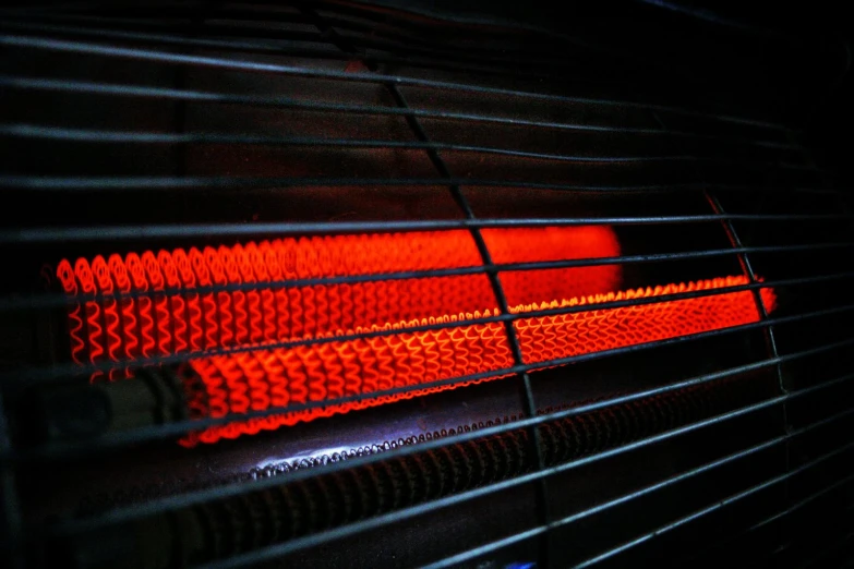 red light glowing on a black fire place