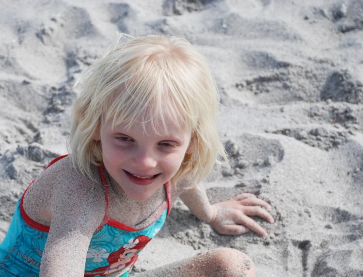 the  smiles while sitting on sand