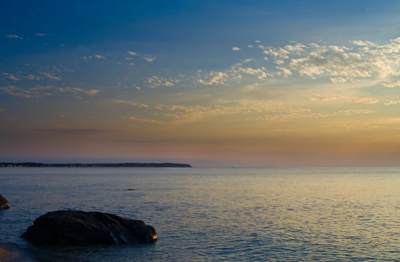 an ocean with a boat on the horizon