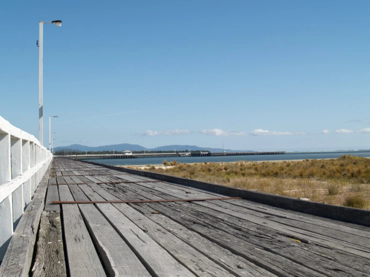 a street and fence near the water