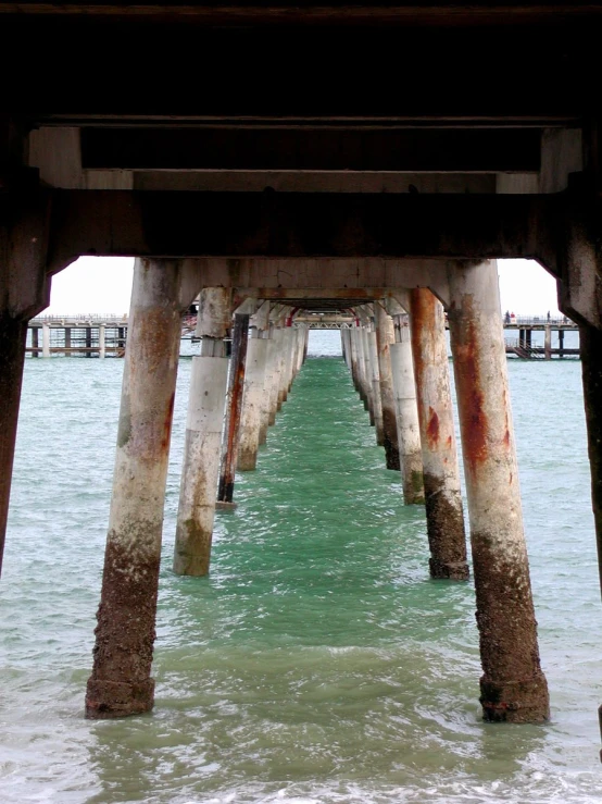 the water is looking blue and green at this pier