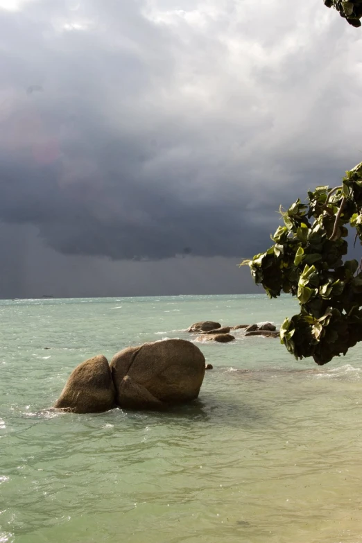 some large rocks sitting in the middle of water