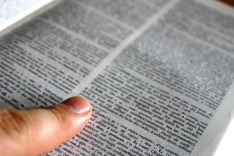 hand reading a book with a shallow focus on the middle