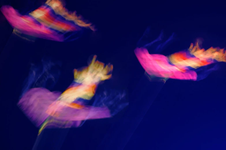 blurry images of kites flying in the air