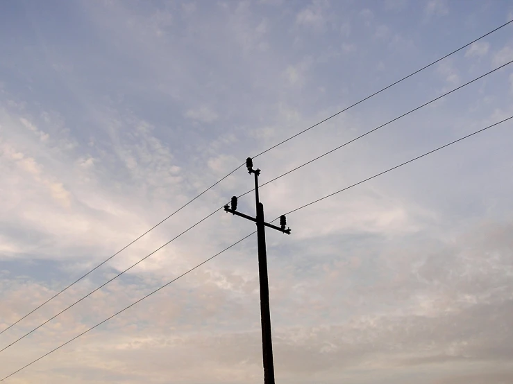 electrical poles with telephone towers in the background