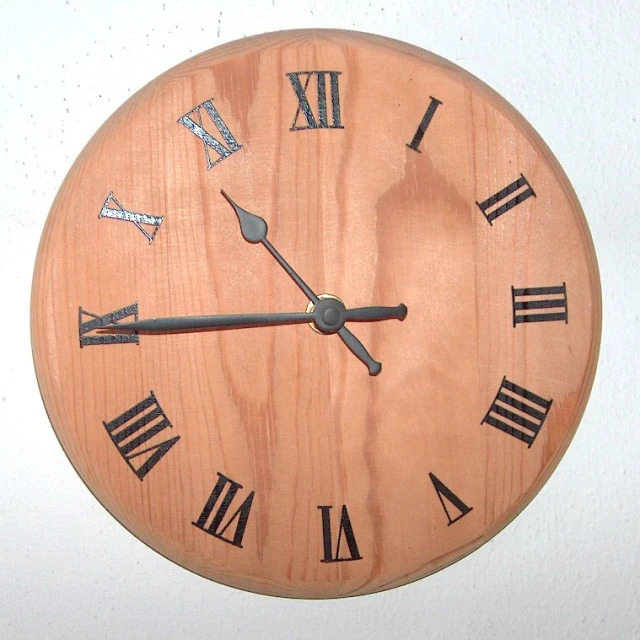 a wooden clock with roman numerals on it