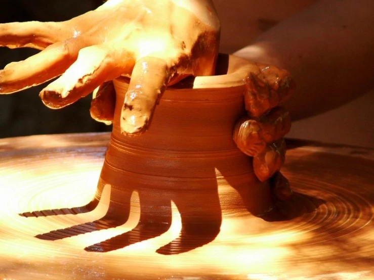 someone is kneading a pot on pottery and using it