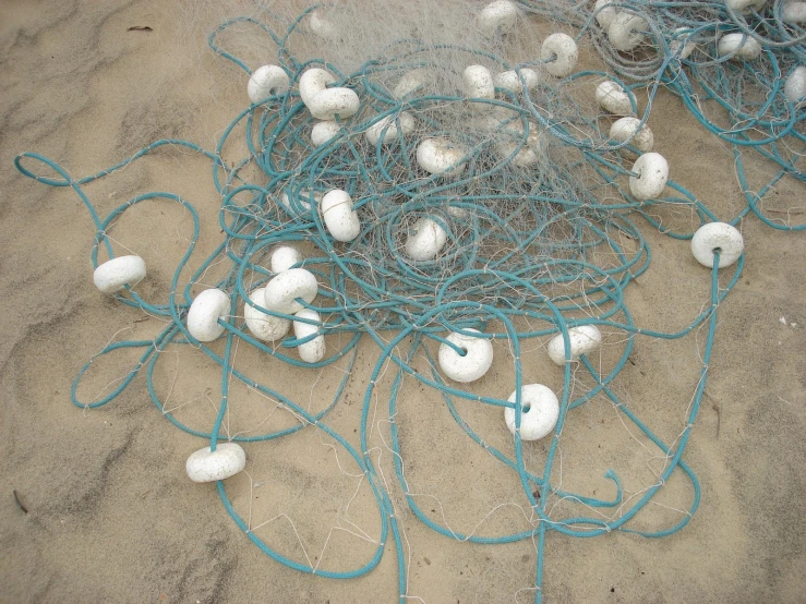 many green and white ropes are wrapped around a ball