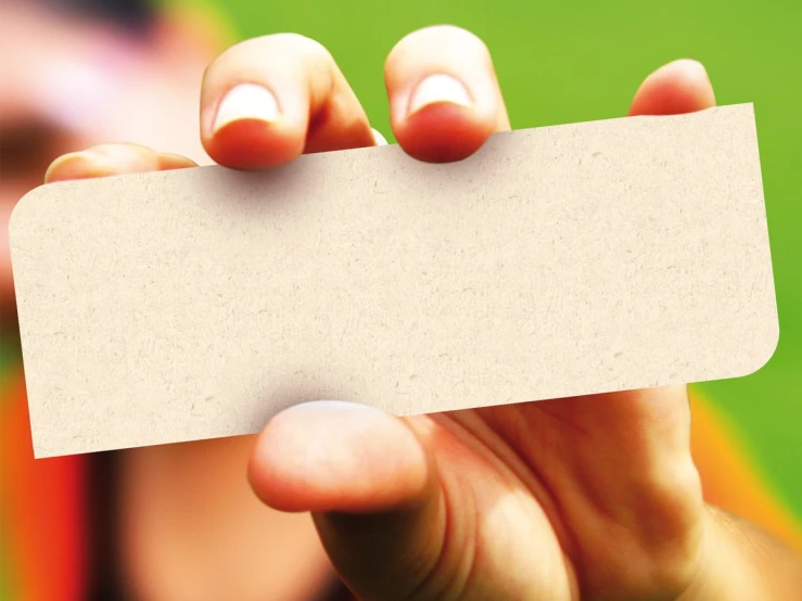 a woman holding up an empty card with a smile on it