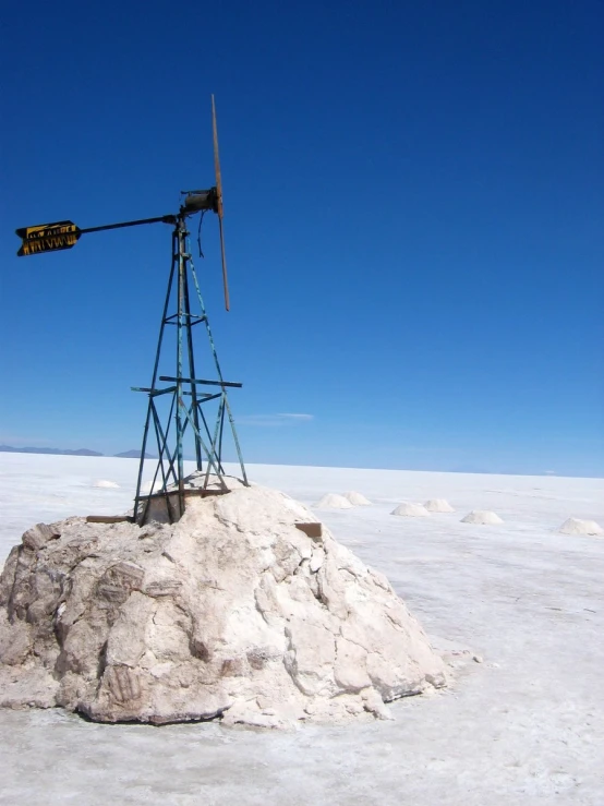 an old windmill on a rock in the desert