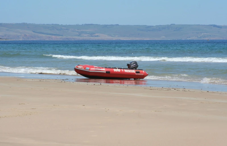 an inflatable motor boat parked on the beach