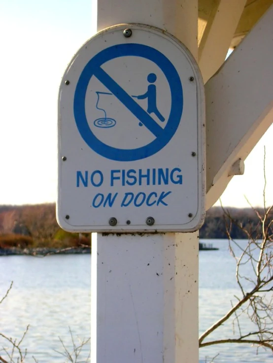 a sign that states no fishing or on dock