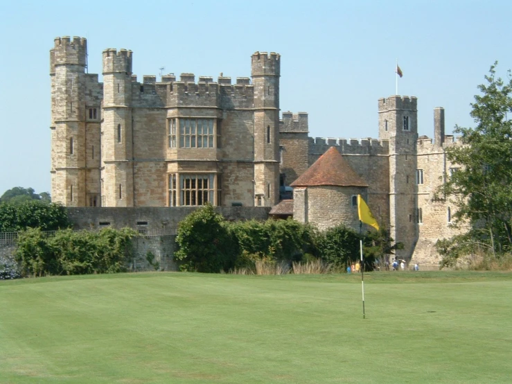 the two people are playing golf outside the castle