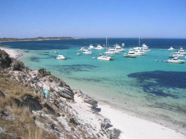 there are many boats in the clear blue water