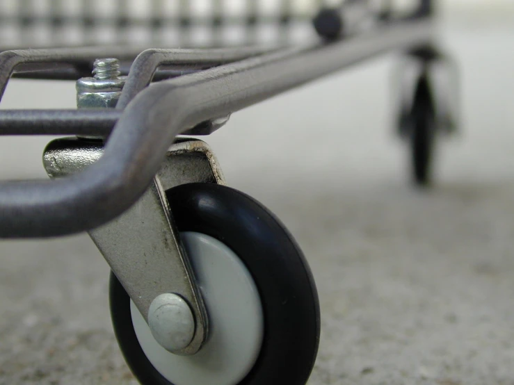 an empty black and white wagon sitting on the ground