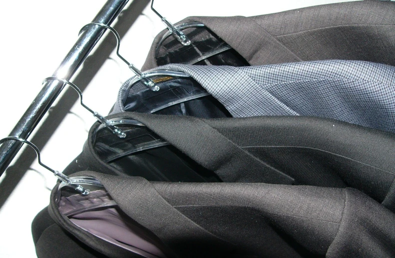 a suit jacket hanging on the back of a jacket rack