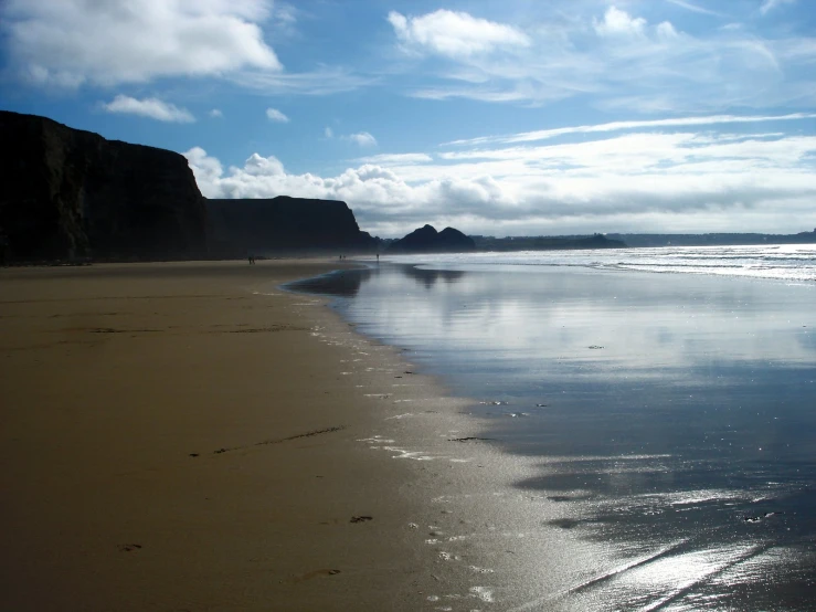 a lone man is walking along the beach