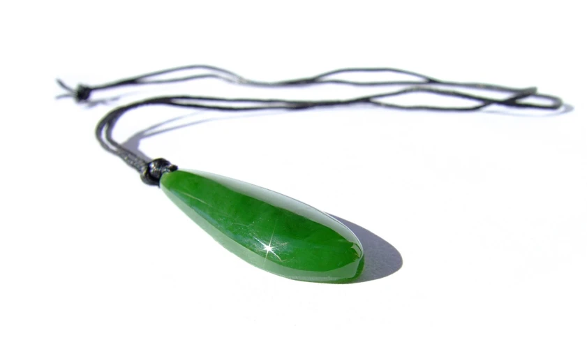a long green, black - wire necklace with glass tear pendant
