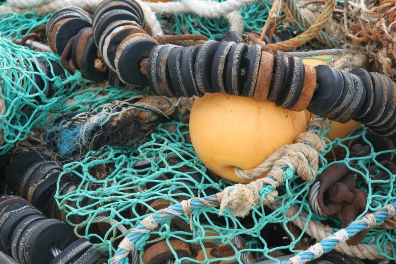 ropes and buoys piled together with an apple on top