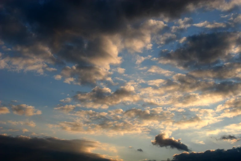 the sky in front of a dark cloud covered sky