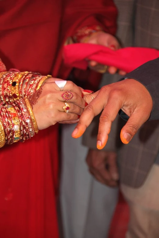 a bride and groom holding hands as they take the altar