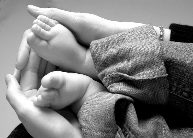 a person holding a baby in their arms