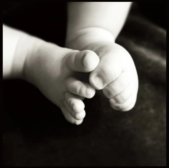 small baby's hand with the arm extended to the side of its body