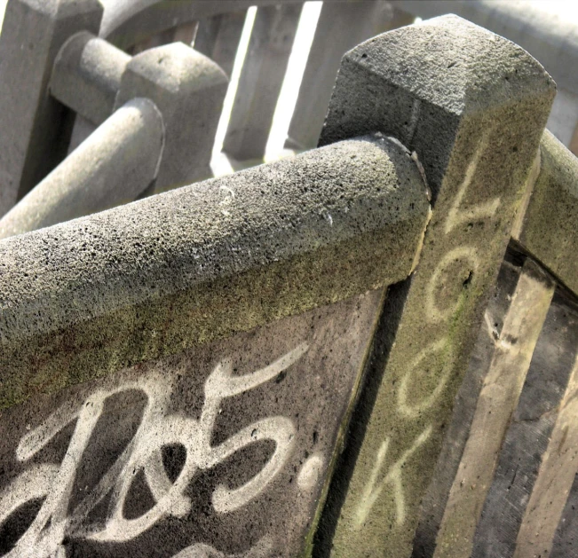 a cement bench with graffiti written on it