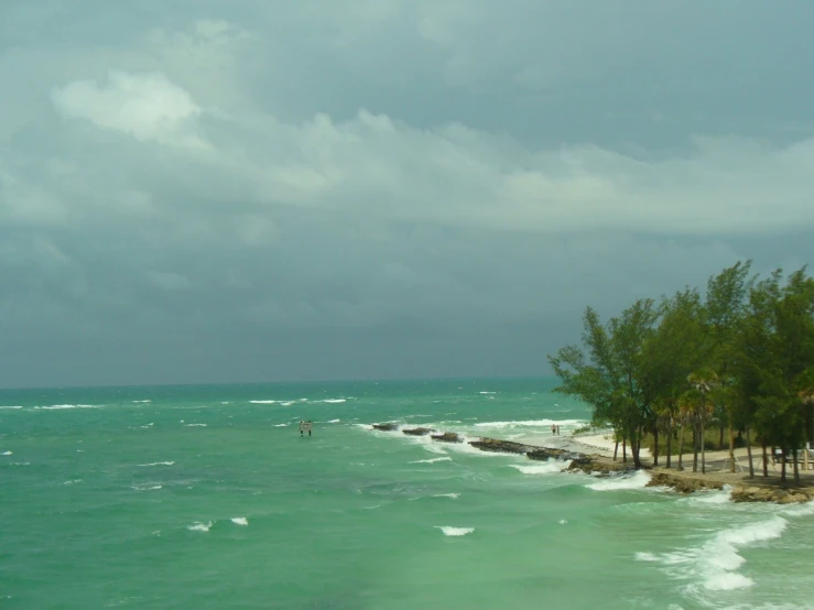 a view of the beach and ocean in a cloudy day