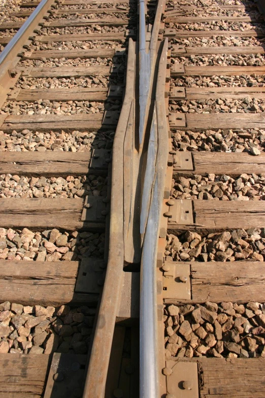 a close up of a train track with one single section removed