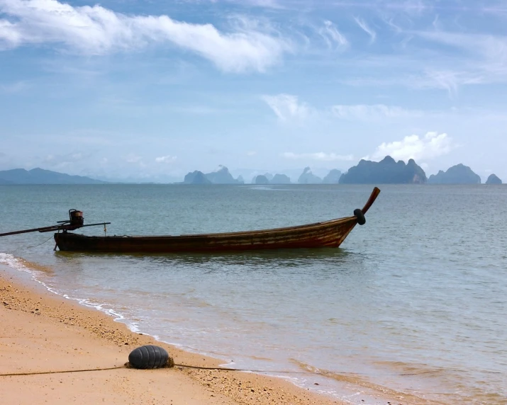 the boat is in the water on the beach