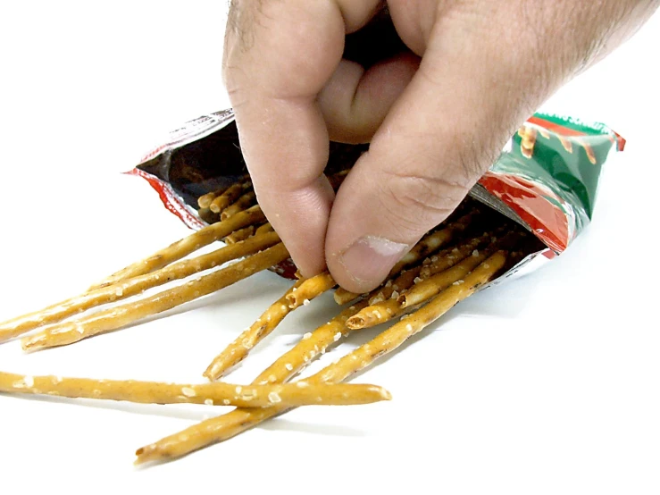 an overcooked hand picking up food from a bag