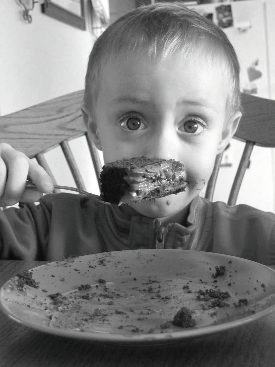 a young child eating a large plate of food