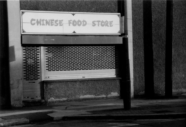 chinese food store on the sidewalk near an older building