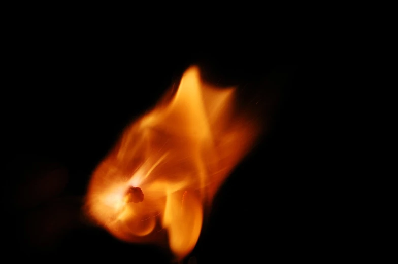 a close up po of a black background with orange smoke