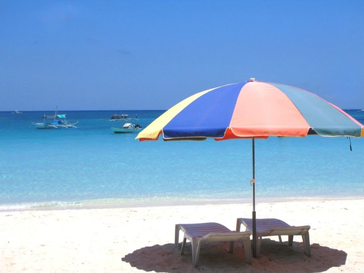 a large umbrella that is next to some chairs