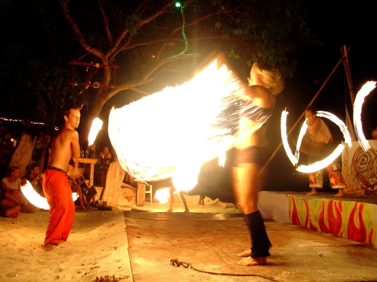 people standing around with fire and water jugs on the ground
