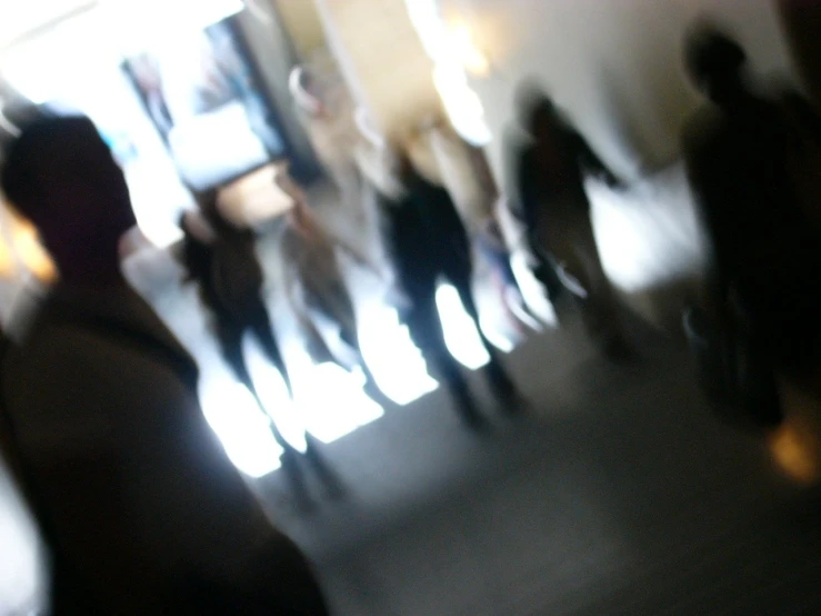 blurry pograph of people walking outside building