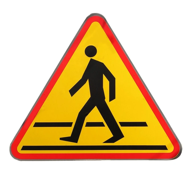 a pedestrian crossing sign in the center of a street