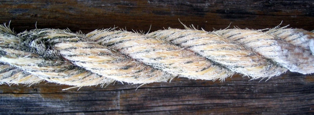 a rope hanging on a wooden structure