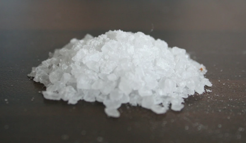 some white flakes of food sitting on a table