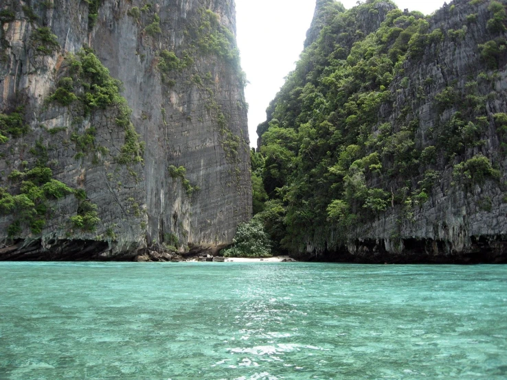 a view of an ocean with mountains and cliffs