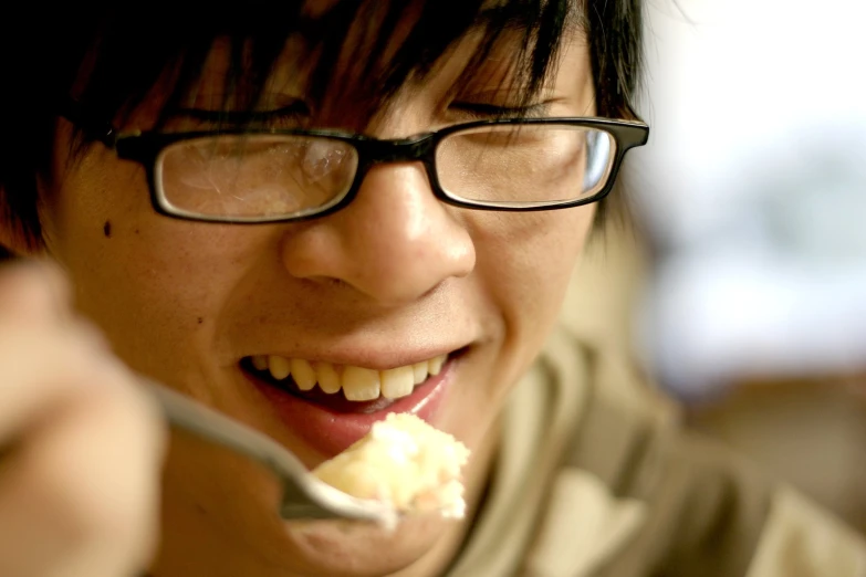 asian woman eating white rice with a spoon