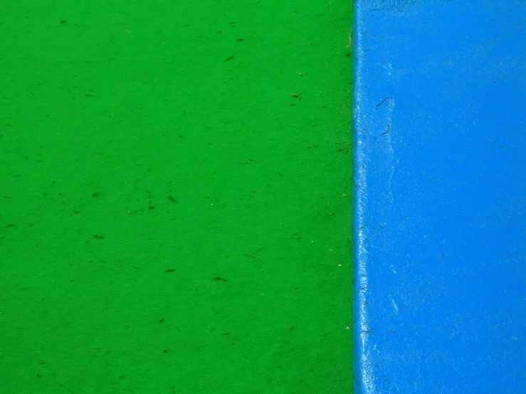 a blue and green section of the ground with dirt