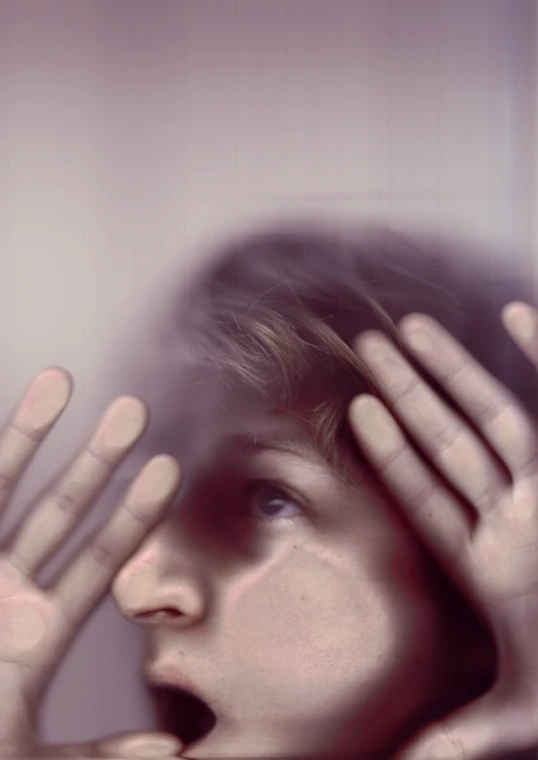 a woman holds her hands on her forehead