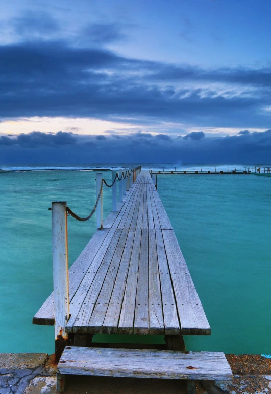 a small boat dock sitting on the side of a beach