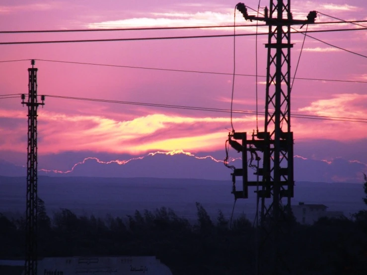 the sky at sunset from the back of an electrical tower