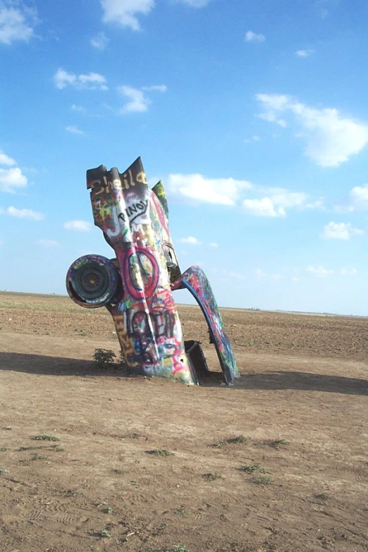 large outdoor art piece sitting in an empty field